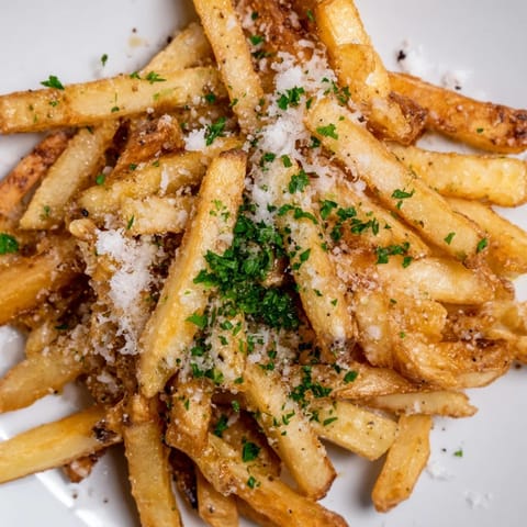 Crispy baked Truffle Parmesan Fries served hot as a decadent vegetarian side or snack.  