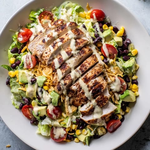 Crunchy Taco Chicken Salad topped with diced avocado, green onions, and fresh cherry tomatoes for a vibrant, Tex-Mex inspired meal.
