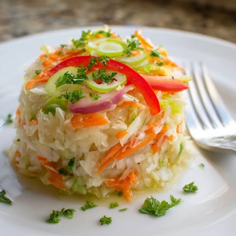Freshly tossed Sauerkraut Slaw featuring fermented cabbage, crisp vegetables, and a tangy Dijon mustard dressing in a rustic serving bowl, perfect as a probiotic-rich vegan side dish.