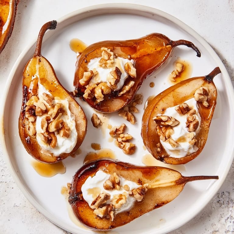Close-up of baked roasted pears, topped with walnuts, yogurt, and drizzled honey—a sweet treat.