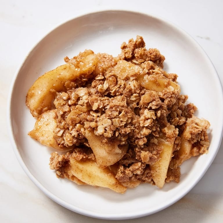 Deliciously baked Apple Crisp with a crispy oat topping, served warm and inviting.