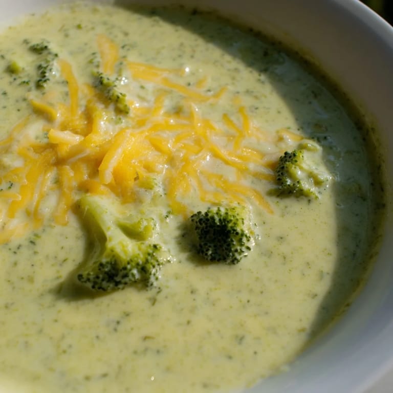 Hearty Broccoli Cheese Soup, a vibrant green soup filled with broccoli florets and golden cheese.