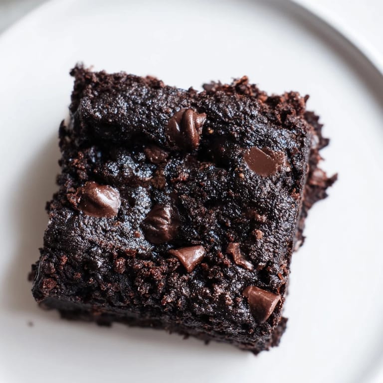 Warm Black Bean Brownies, a gluten-free dessert, sliced and served, perfect for a treat.