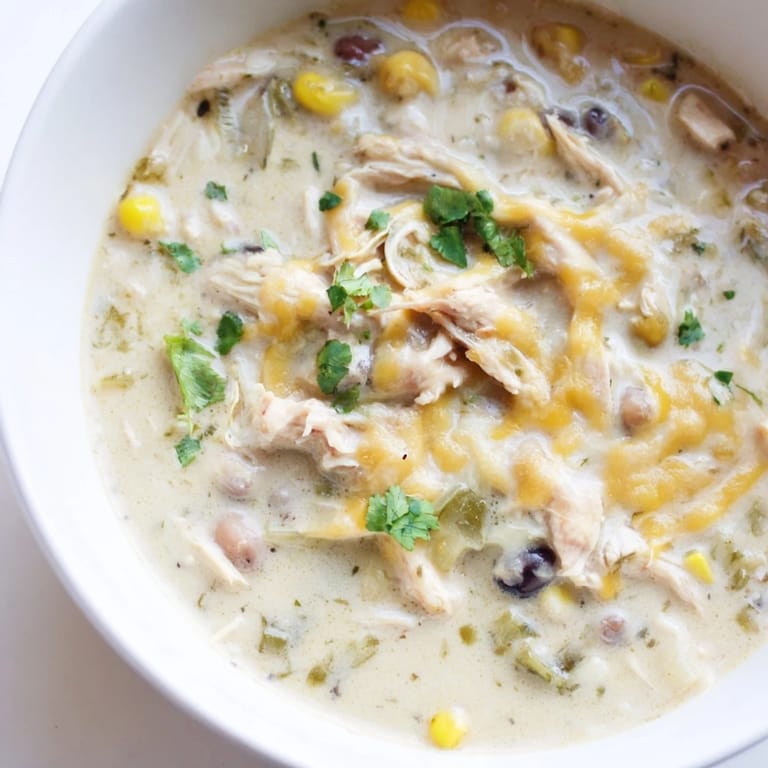 Spoonful of rich and flavorful Chicken Poblano Soup, garnished with fresh cilantro on top.