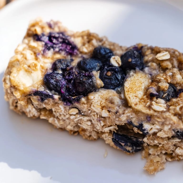 Freshly cut Blueberry Banana Oatmeal Protein Bars showing the texture, packed with oats, bananas, and protein.