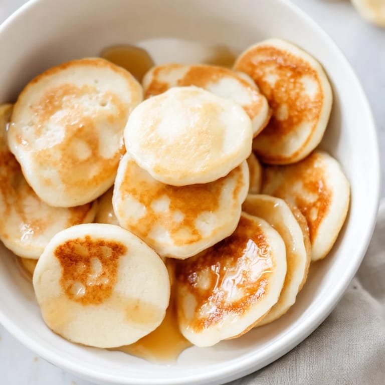 Close-up of adorable golden pancake cereal, waiting to be enjoyed with cold milk and syrup.