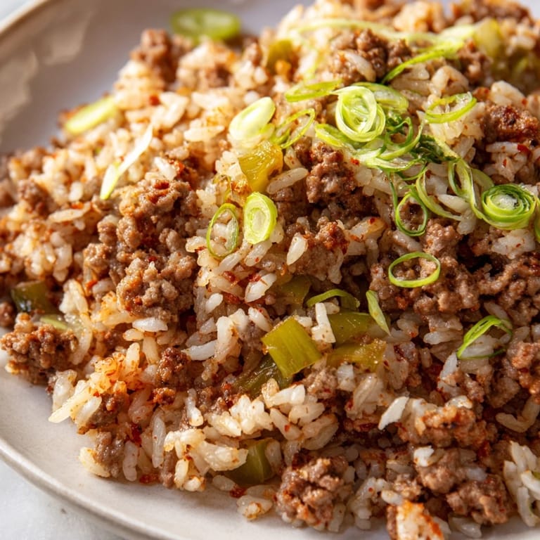 Enjoy the hearty aroma of this homemade Cajun Dirty Rice, cooked to perfection in a Dutch oven.