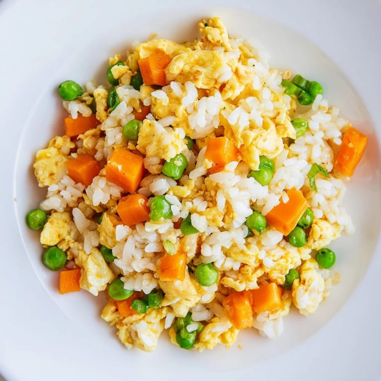 Enjoy this easy Egg Fried Rice: warm rice stir-fried with veggies in soy sauce.